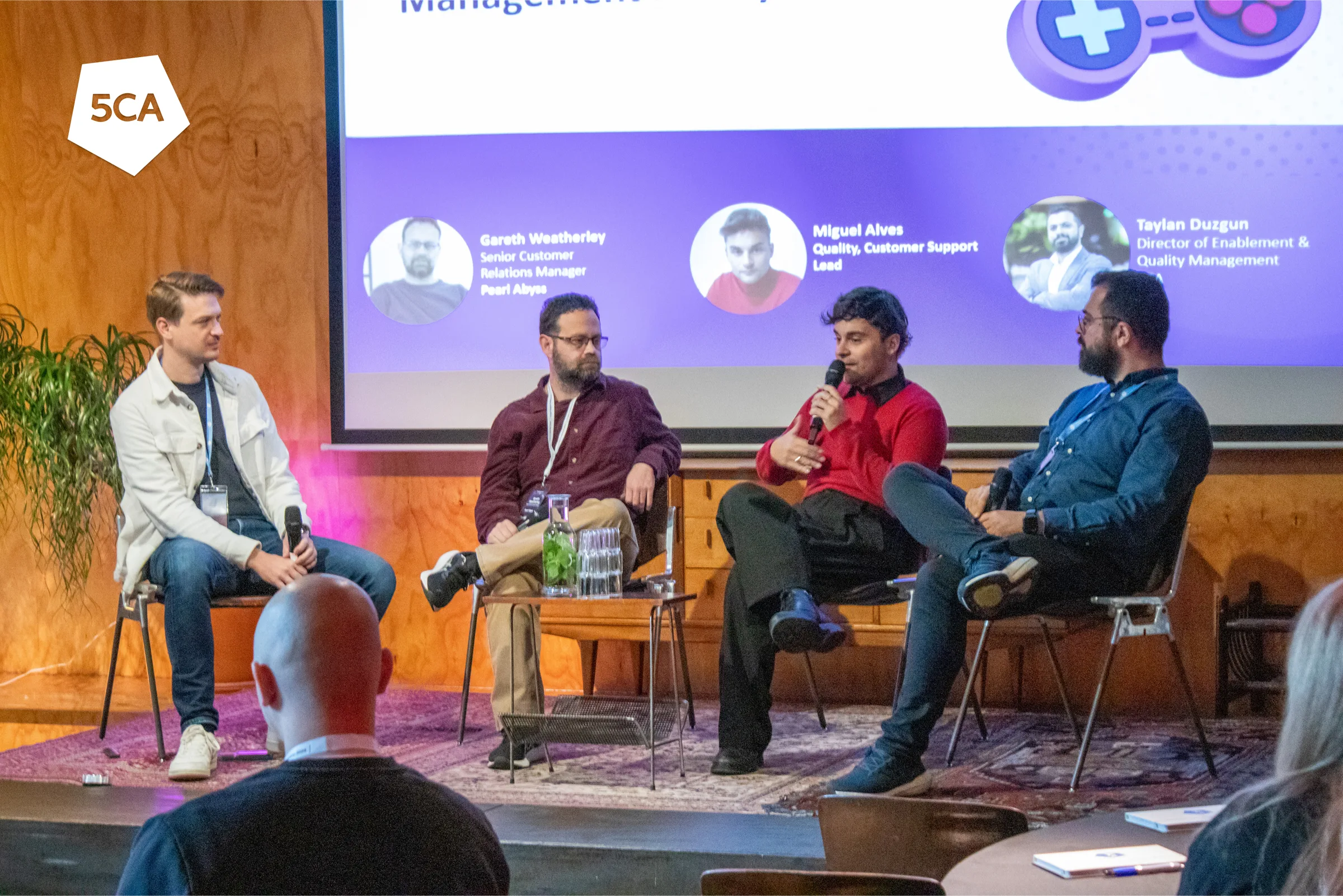 Speakers on the stage of Player Support Meetup Amsterdam 2024