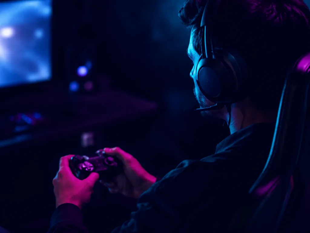 Blog cover image: A person playing a game with their controller at home